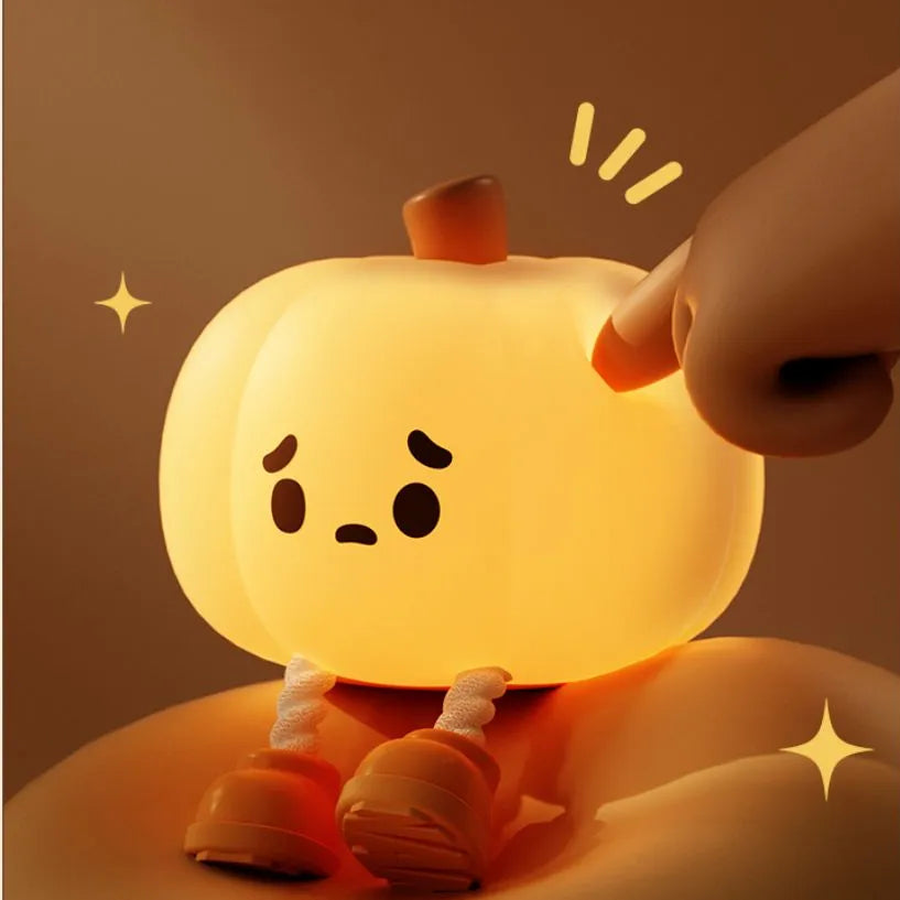 A hand tapping the top of the pumpkin to change the brightness